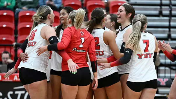 The YSU volleyball team celebrates on the court after its victory over Mercyhurst.
