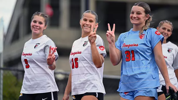 Women's Soccer players Kate Makkas, Sara Felder and Cami Givens enter Farmers National Bank Field for pregame warmups