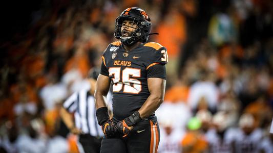 Oregon state linebacker Omar Speights flexes his muscles 